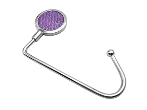 Detail of silver metal desk hook featuring purple glitter inlay on a white background