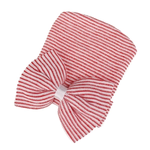 Detailed view of the red and white striped knit baby hat with a large bow decoration