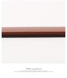 Close-up of deep brown leather belt edge showing fine texture and polished finish