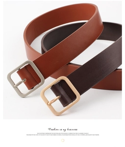Detail of tan and dark brown leather belts with square metal buckles on white background
