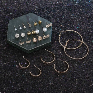 Set of 12 pairs of gold earrings with moon, stars, pearls and crystal studs
