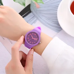 Detailed view of a purple silicone watch with matte finish worn on a wrist in a lifestyle setting