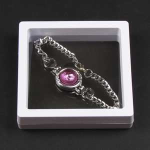 Silver chain bracelet with purple relief inlay inside a white PE film floating display box