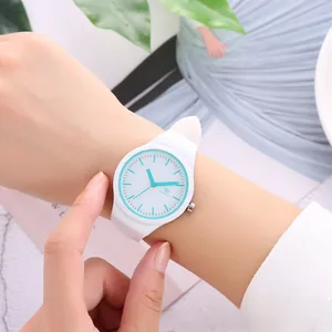 Detailed close-up of a white silicone strap watch with light blue accents on a wrist