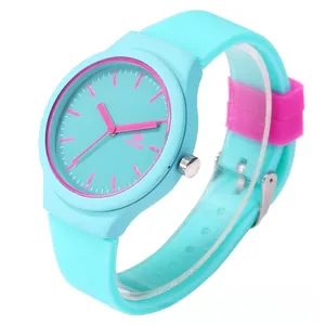 Detail of pink dial and light blue silicone strap of a quartz watch for kids