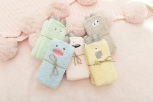 Detail of coral fleece towels featuring cute monster faces and plush soft texture
