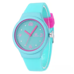 Close-up of sky blue silicone watch featuring pink numerals and sparkling rhinestone accents
