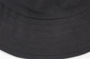 Detail view of reinforced parallel stitching on a black cotton bucket hat brim