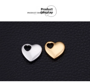 Polished stainless steel heart pendants in gold and silver on black leather