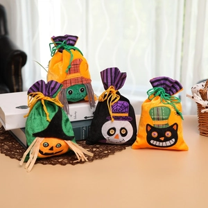Detail of four Halloween non-woven drawstring candy bags with pumpkin and ghost designs