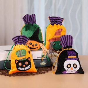Detail of four Halloween velvet drawstring gift bags with pumpkin and witch patches