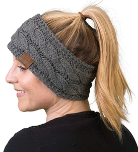 Detail view of a grey knitted headband with cable knit pattern and leather C.C tag