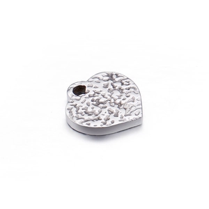 Minimalist silver heart pendant in stainless steel with textured surface and top ring