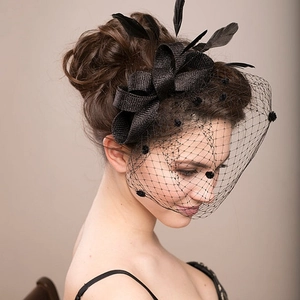 Side view of elegant black fascinator hat with feather bow and dotted mesh bridal veil