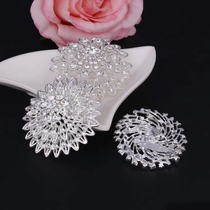 Detail of silver alloy flower brooches with clear rhinestones and safety pin clasp