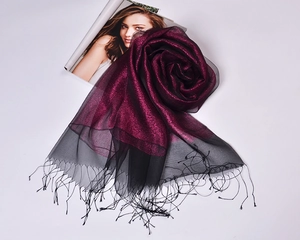 Detailed view of silk organza shawl folded like a rose with elegant black tassels