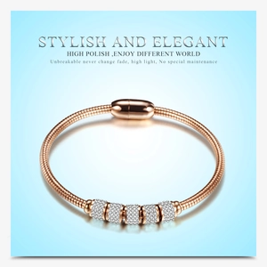 Close-up of rose gold snake chain bracelet with five sparkling crystal-encrusted sliders