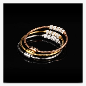 Macro detail of 3mm snake bone chain bracelets with magnetic clasp in gold and silver