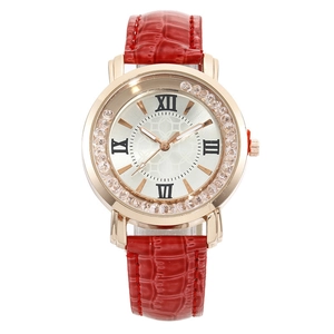 Detail of red leather strap watch with rose gold case and rhinestone bezel
