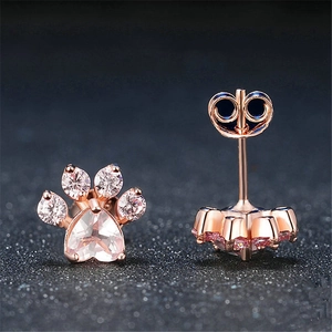 Rose gold cat paw earrings with pink crystal and zircon stones shown from two angles