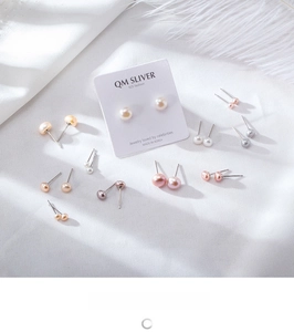 Close-up of assorted natural freshwater pearls on 925 sterling silver studs