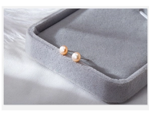 Macro view of natural champagne pink pearl earrings on 925 sterling silver posts