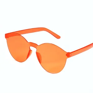 Orange rimless oversized sunglasses with a modern geometric transparent jelly frame