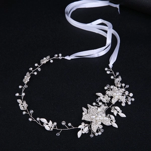 Silver bridal headband featuring pearls, rhinestones, and delicate flower leaf designs