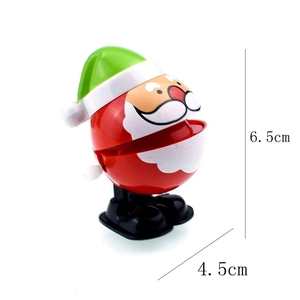 Macro view of cartoon Santa wind-up toy showing dimensions of 6.5cm height and 4.5cm width