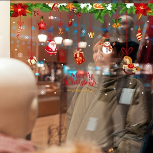 Christmas window stickers with Santa and snowman on a festive shop display glass