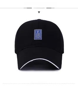 Front view of black twill cotton baseball cap with blue golf patch and white layered brim