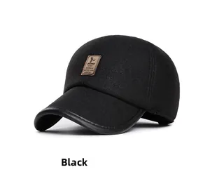 Detail of black winter baseball cap with leather trim and brown logo patch