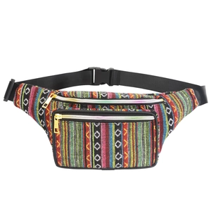 Detail of bohemian waist bag showing colorful woven stripes and metal zipper texture