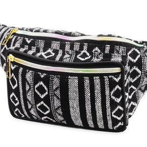 Close-up of black and white geometric pattern fanny pack with golden zippers on white background