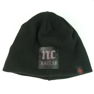 Detail of black fleece beanie with leather patch and a red snowflake woven label