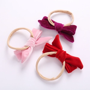 3-piece set of baby nylon headbands with velvet bows in pink, fuchsia, and red colors