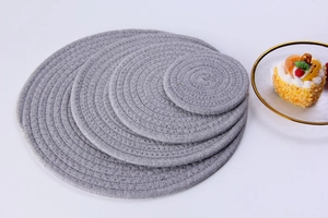 Macro detail of gray cotton rope woven placemats in multiple sizes for table protection