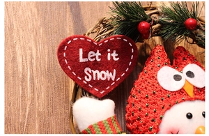 Close-up of owl and snowman Christmas wreath with Let it Snow red heart sign