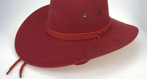 Detail of burgundy faux suede cowboy hat with braided strap and metal eyelets