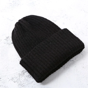 Minimalist black knitted beanie for children with thick warm texture for winter comfort
