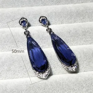 Elegant 50mm long teardrop drop earrings with dark blue crystals and silver accents