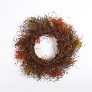 Ghirlanda autunnale con rami di rattan, foglie di acero e bacche per decorazione