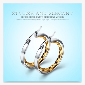 Detail of 28mm hollow double-layer round earrings with silver and gold twisted metal finish