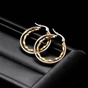 Two-tone 28mm hollow round hoop earrings in gold and silver finish on black leather