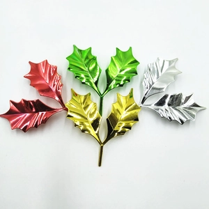 Metallic finish holly leaves cake toppers in red, gold, green, and silver colors