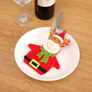 Close-up of reindeer felt cutlery bag on a white plate for Christmas dinner setting