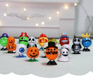 Close-up of assorted Halloween wind-up toys including pumpkin, skull, and ghost figures