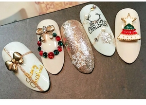 Macro view of Christmas nail art charms with festive snowflake and 3D tree designs