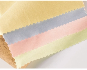 Macro view of assorted microfiber cleaning cloths with decorative zigzag serrated edges