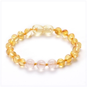 Detail view of Baltic amber baby bracelet with pink beads and a screw clasp closure